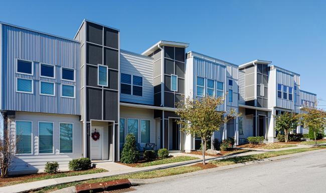 a building with trees and bushes in front of it