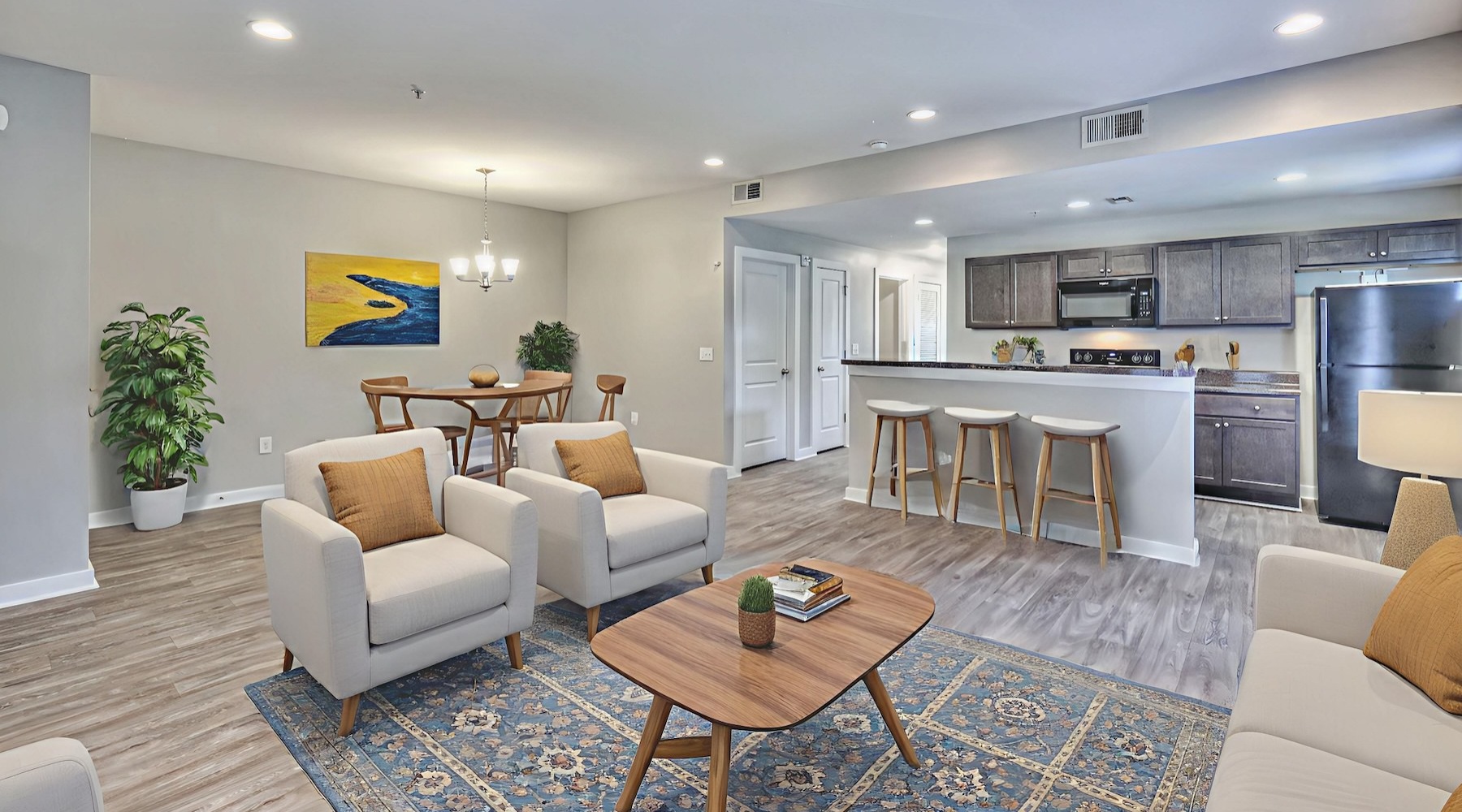 living room with a couch coffee table and view of the kitchen