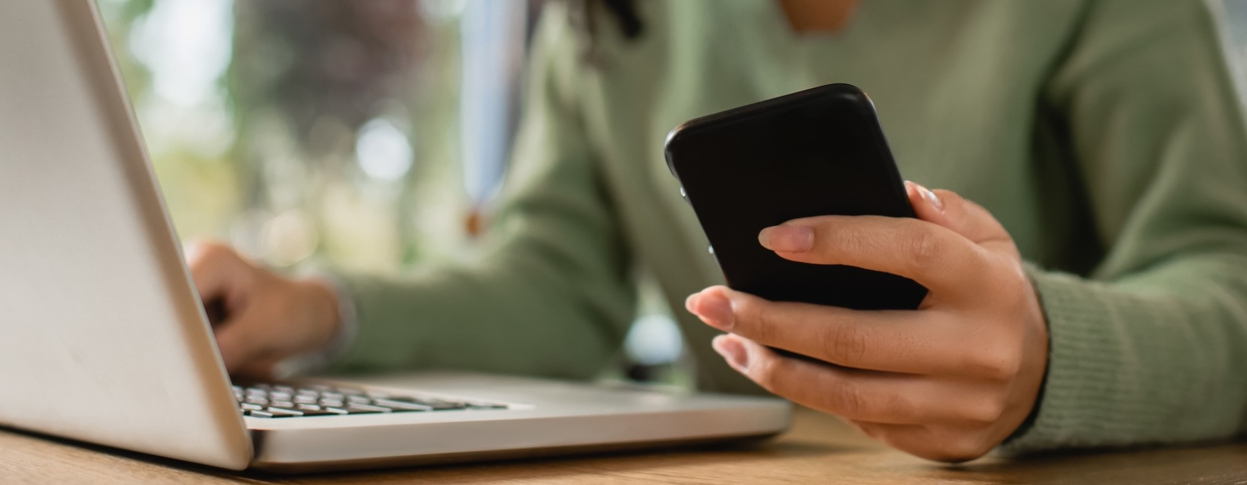 a woman on her computer and on her cell phone