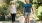 a man and a woman walking a dog on a leash
