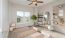 a room with a rug and a rug and a fan