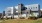 a large white building with a lawn in front of it